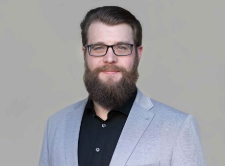 Portrait of a company employee in professional business attire.